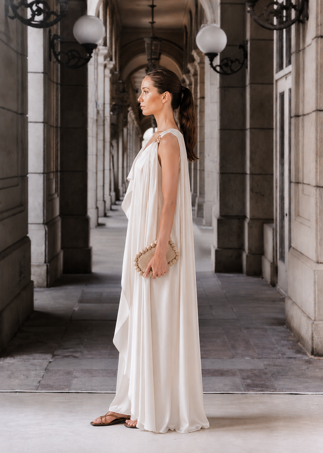 Ivory evening sleeveless draped dress with a golden trim
