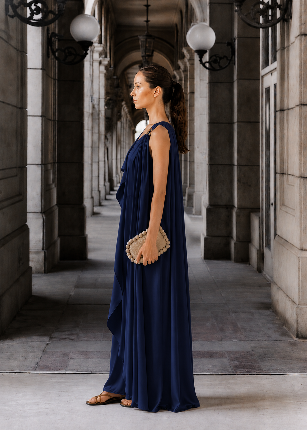 Black sleeveless draped dress with a golden trim