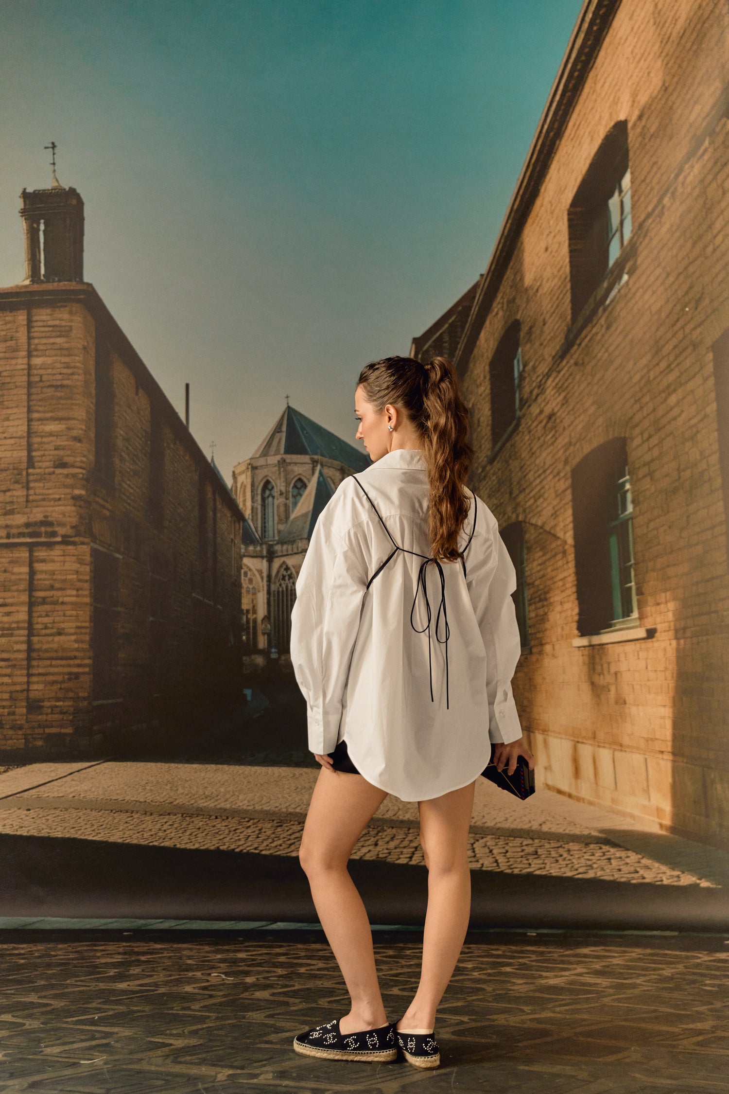 Woman standing on a rooftop with a cityscape in the background