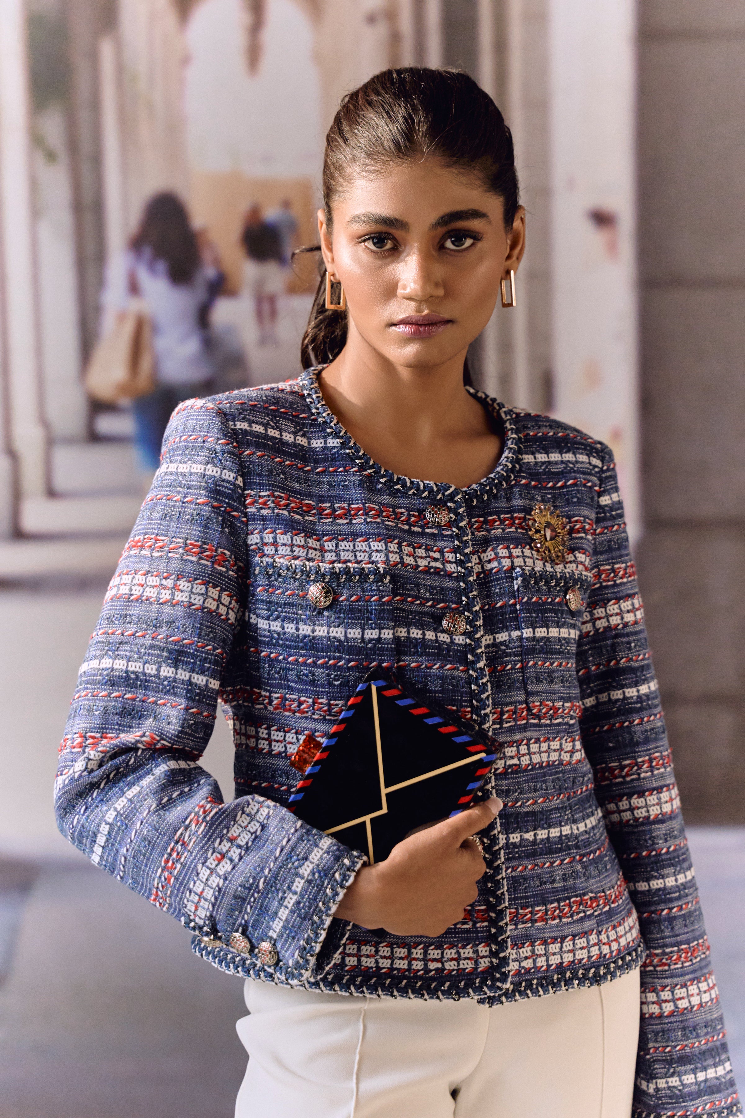 Blue red and white jacket with broach